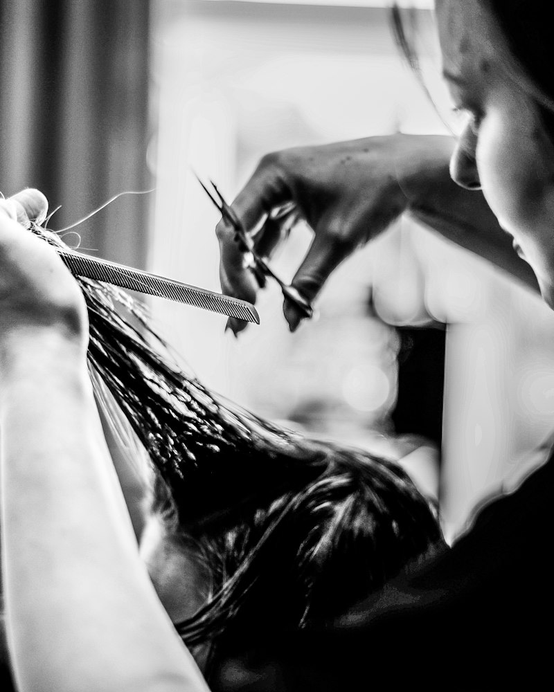 A stylist cutting a client's hair