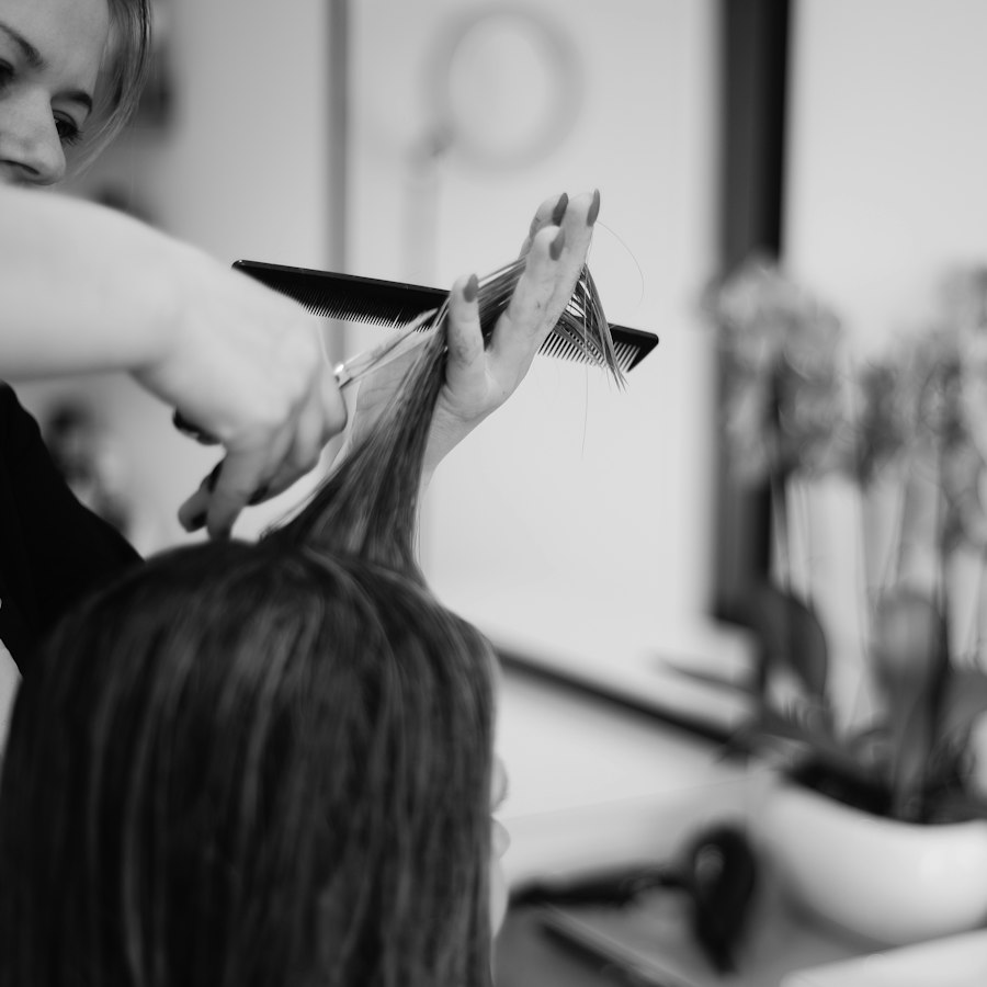 A stylist cutting a client's hair at the studio